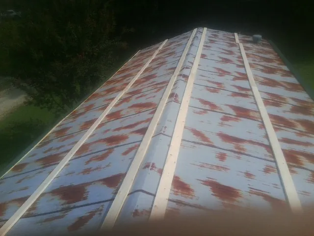 Rusted metal roof panels with new wood purlins before replacement — Storm Damage Roof Repair in Glen Hope by Roofing Brothers