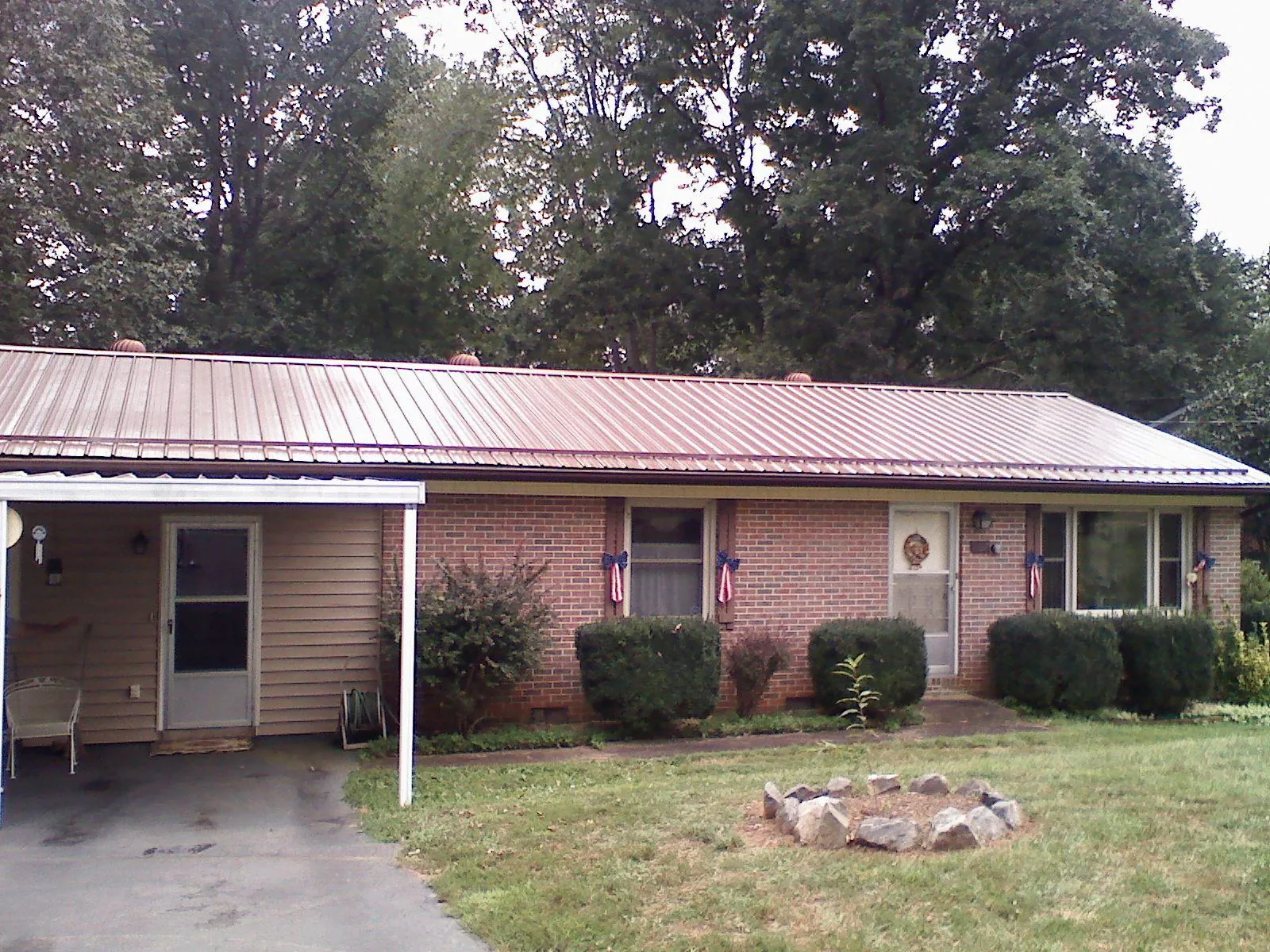 Bronze metal roof and carport on a brick ranch home — Roof Repair work by our crew in Glen Hope